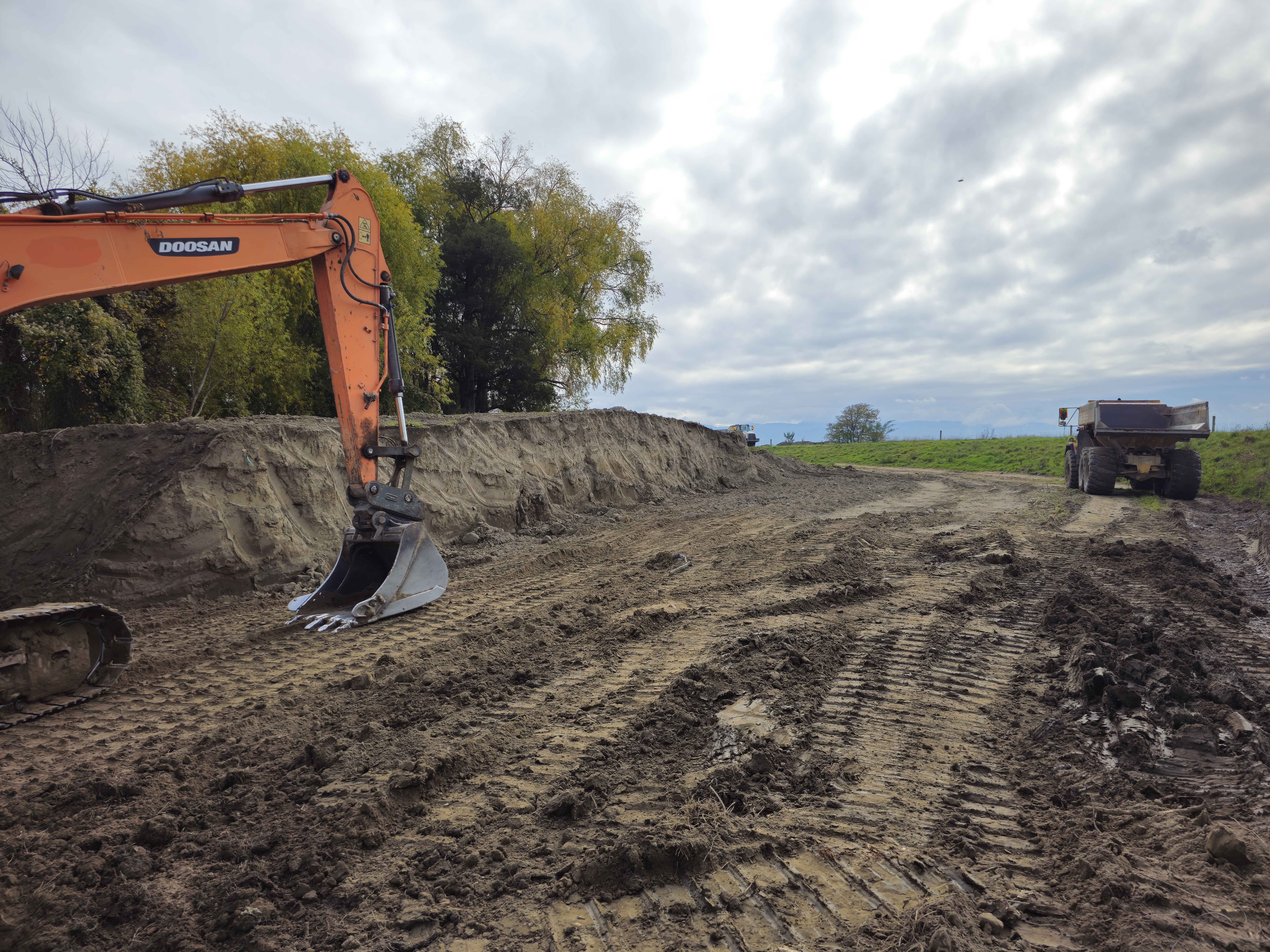 A digger and truck working near the Ruamāhanga River