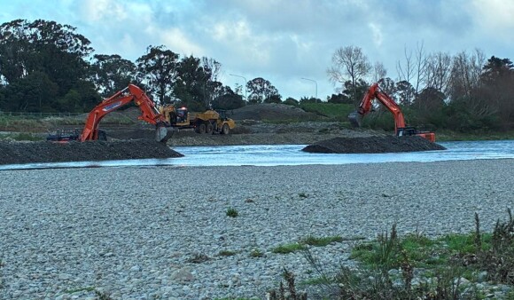 Diggers working on the shore of Te Awa Kairangi/Hutt River 