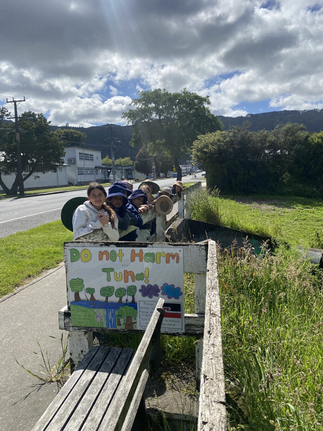 Students from Naenae Primary School pose with their "Do not harm tuna" sign